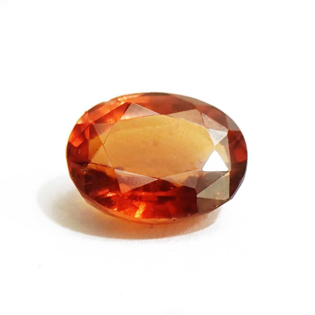 A close-up of a Natural African Gomedh (Hessonite Garnet) gemstone with a deep reddish-brown hue and radiant clarity.