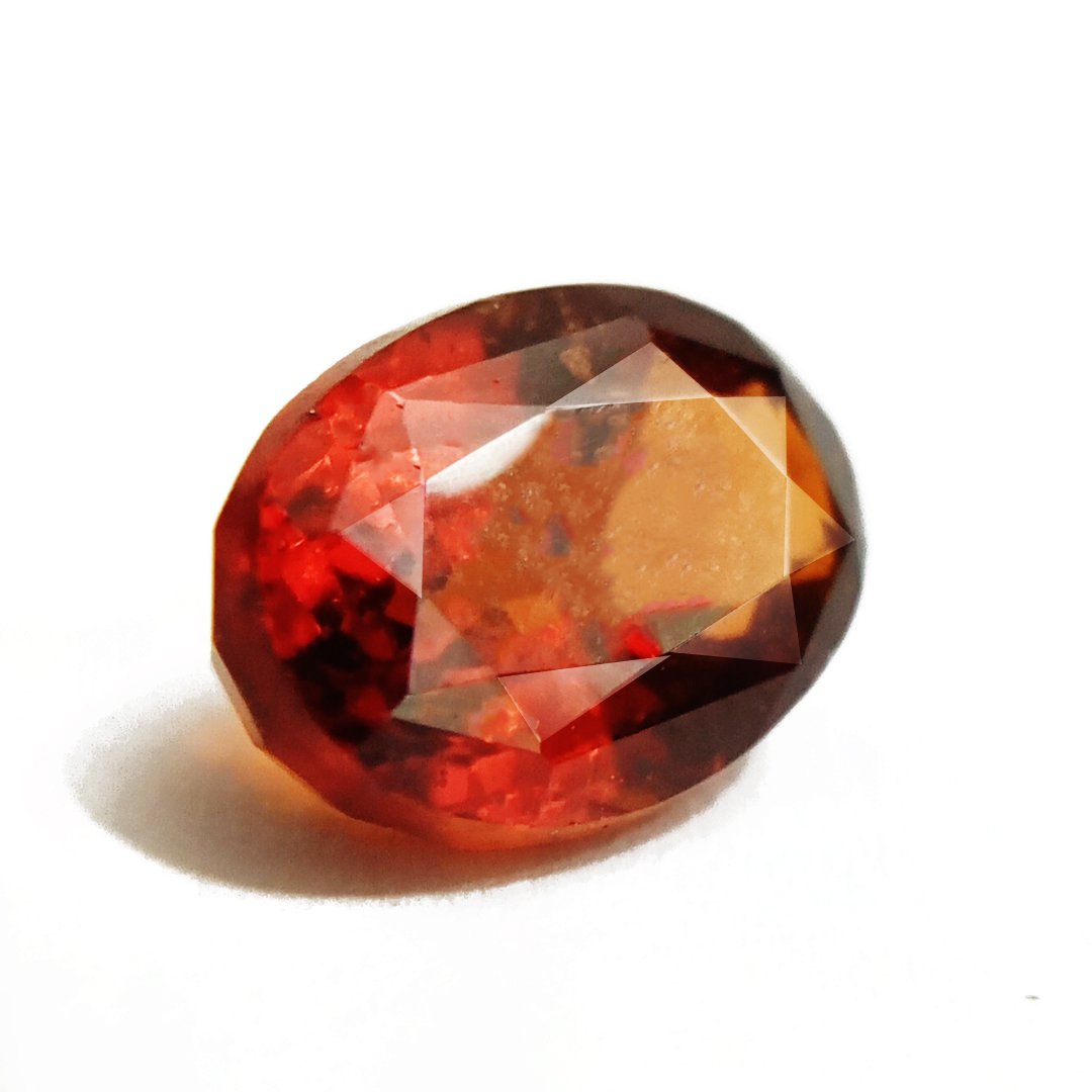 A close-up of a Natural African Gomedh (Hessonite Garnet) gemstone with a deep reddish-brown hue and radiant clarity.