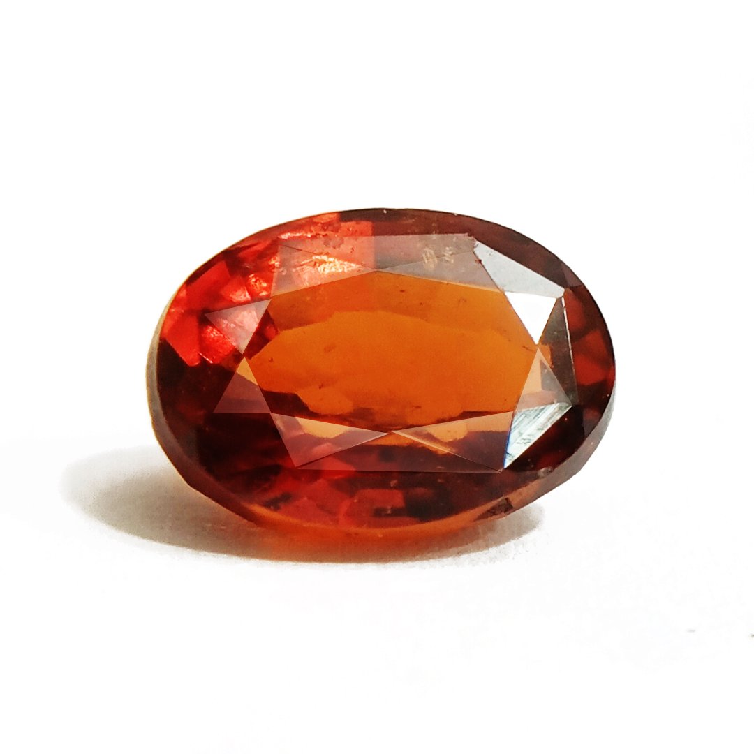 A close-up of a Natural African Gomedh (Hessonite Garnet) gemstone with a deep reddish-brown hue and radiant clarity.