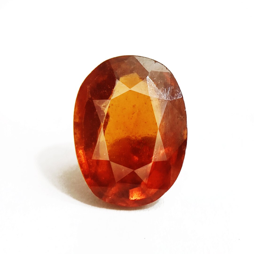 A close-up of a Natural African Gomedh (Hessonite Garnet) gemstone with a deep reddish-brown hue and radiant clarity.