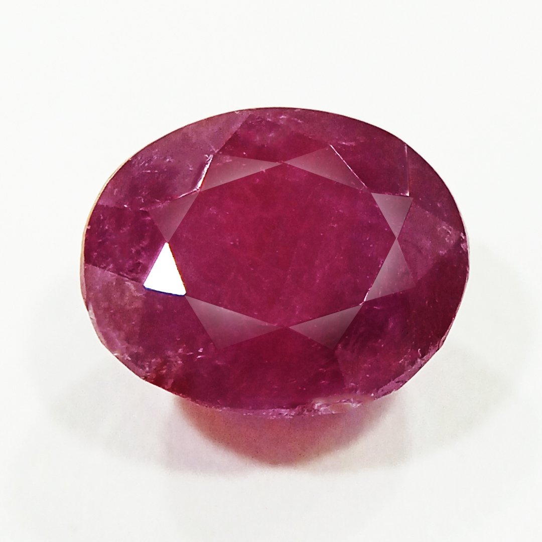 A close-up of a Natural African Ruby gemstone showcasing its rich red hue and brilliant clarity.