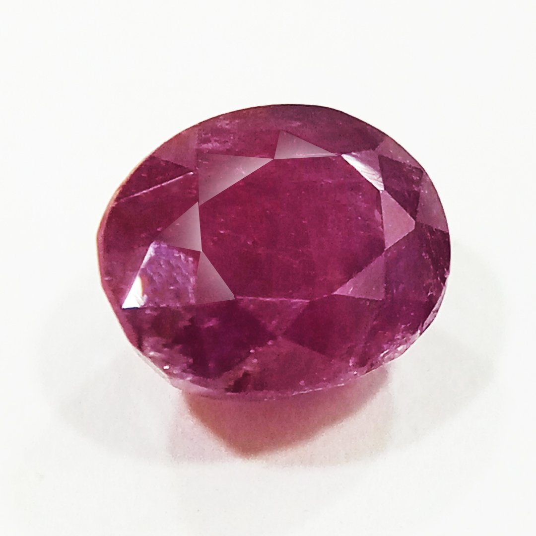 A close-up of a Natural African Ruby gemstone showcasing its rich red hue and brilliant clarity.