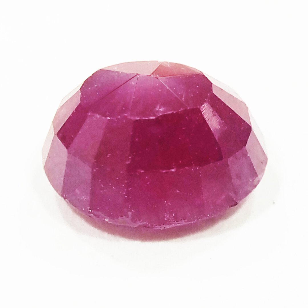 A close-up of a Natural African Ruby gemstone showcasing its rich red hue and brilliant clarity.