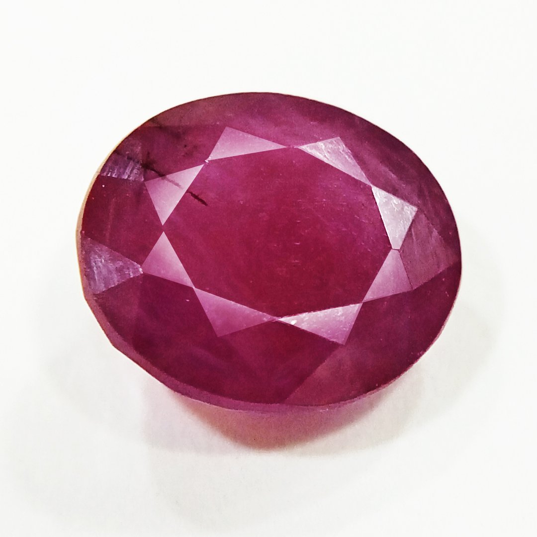 A close-up of a Natural African Ruby gemstone showcasing its rich red hue and brilliant clarity.