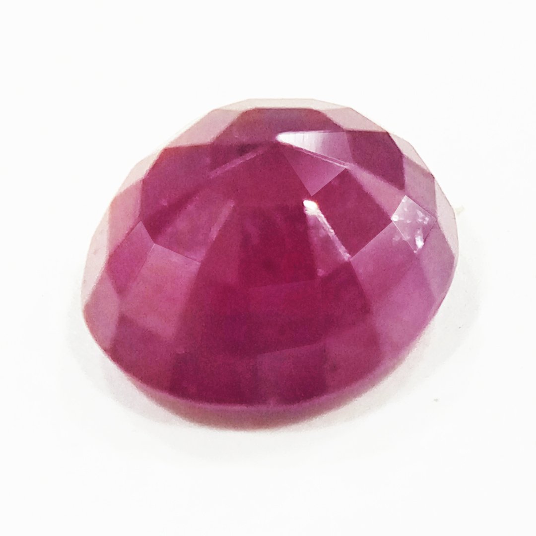 A close-up of a Natural African Ruby gemstone showcasing its rich red hue and brilliant clarity.