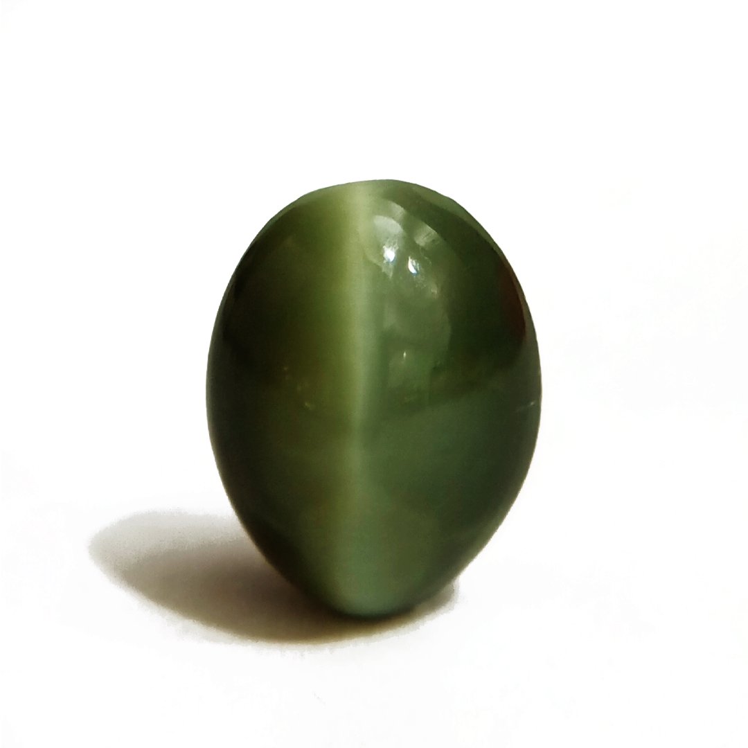 Mystical Indian Cat's Eye gemstone with a striking chatoyant effect, symbolizing protection, insight, and prosperity.