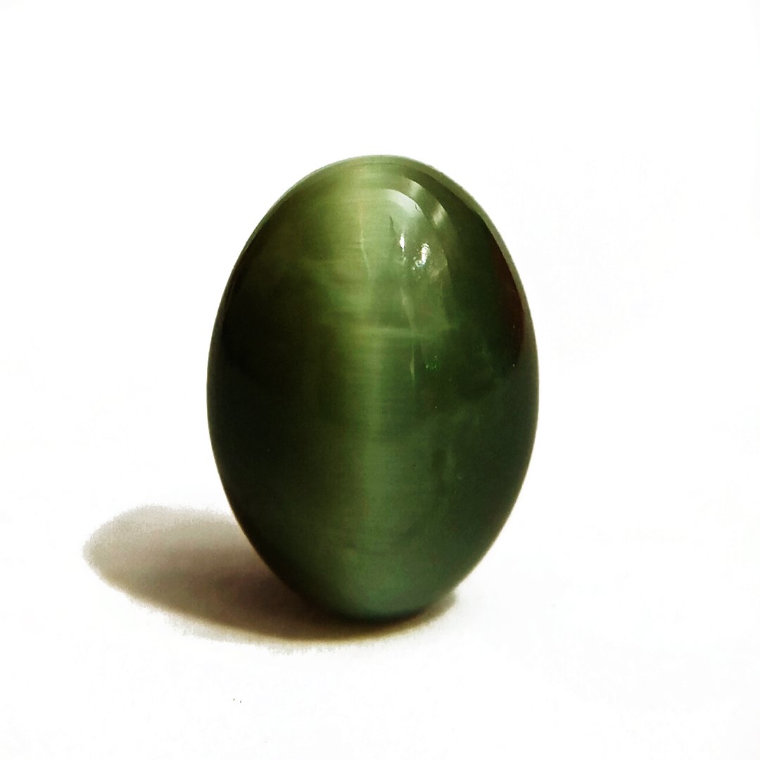 Mystical Indian Cat's Eye gemstone with a striking chatoyant effect, symbolizing protection, insight, and prosperity.