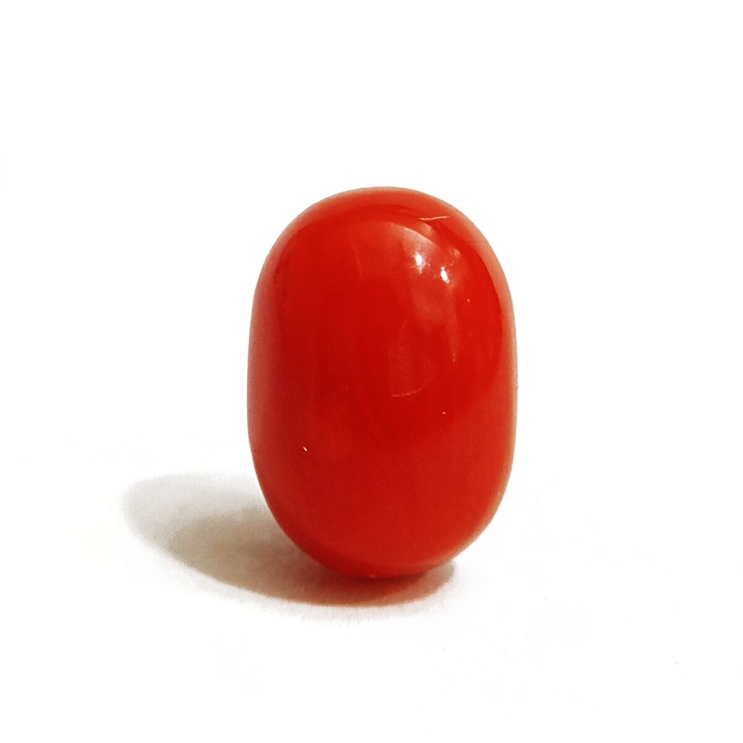 A close-up of a Natural Italian Red Coral gemstone featuring its deep red hue and smooth texture.