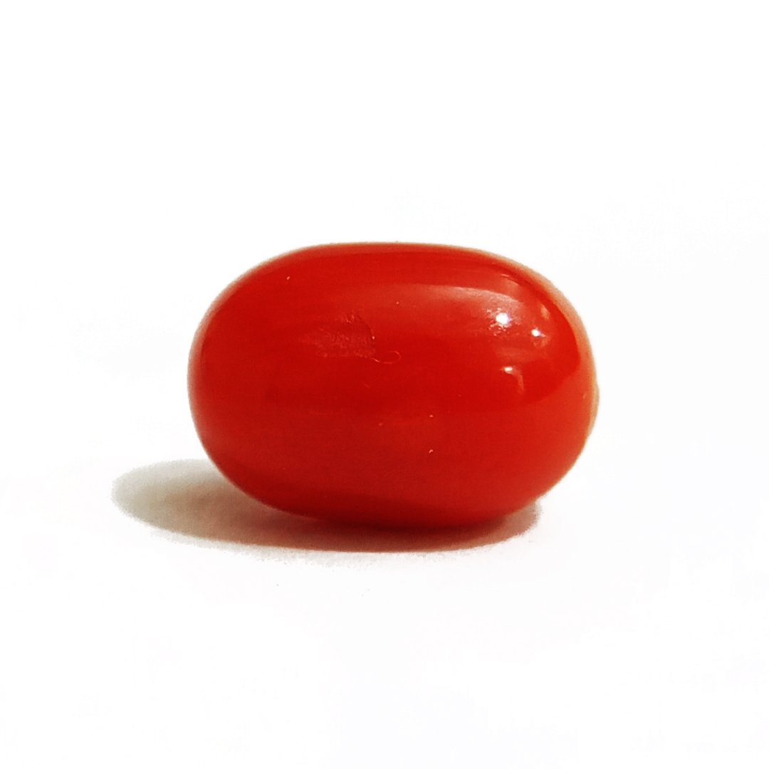 A close-up of a Natural Italian Red Coral gemstone featuring its deep red hue and smooth texture.