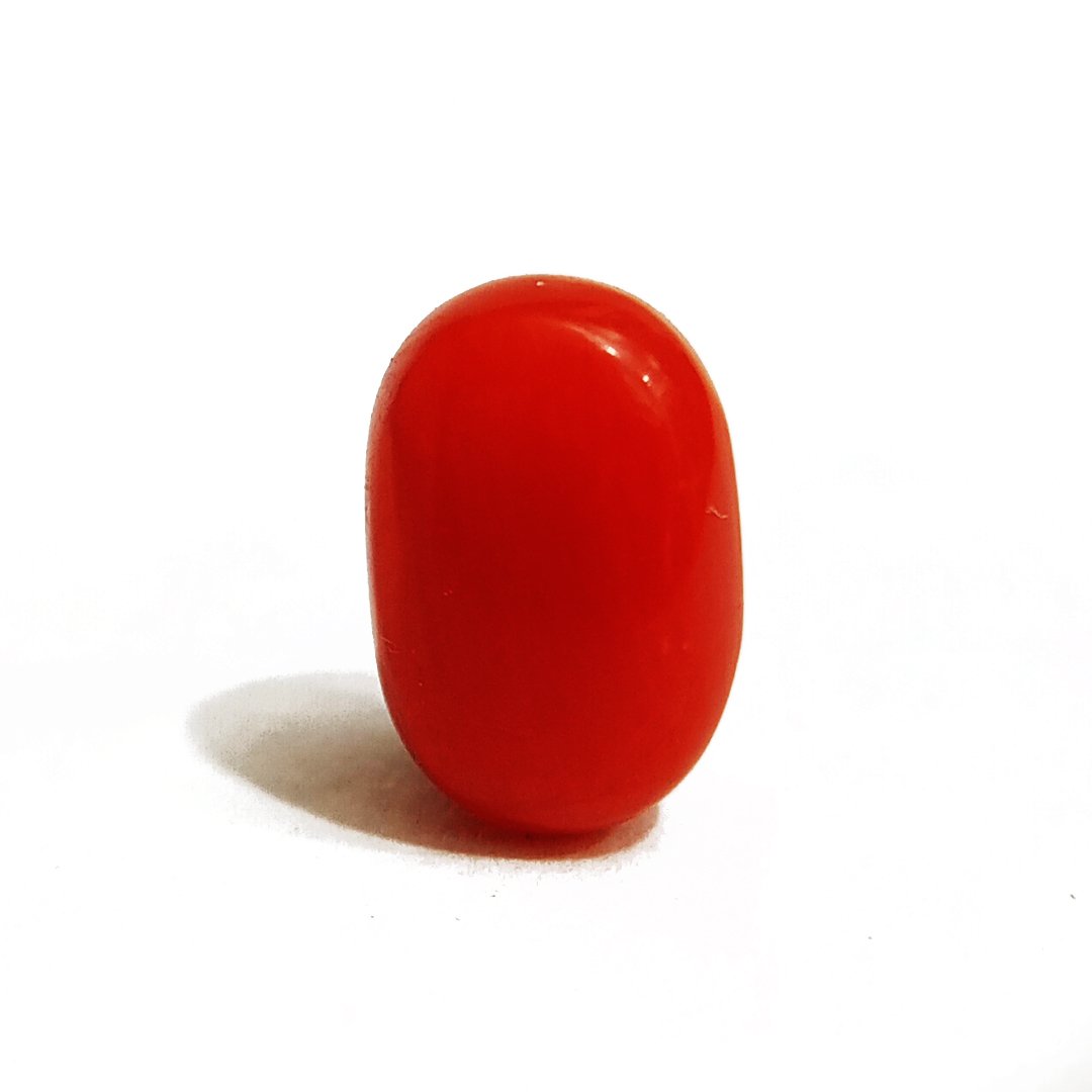 A close-up of a Natural Italian Red Coral gemstone featuring its deep red hue and smooth texture.
