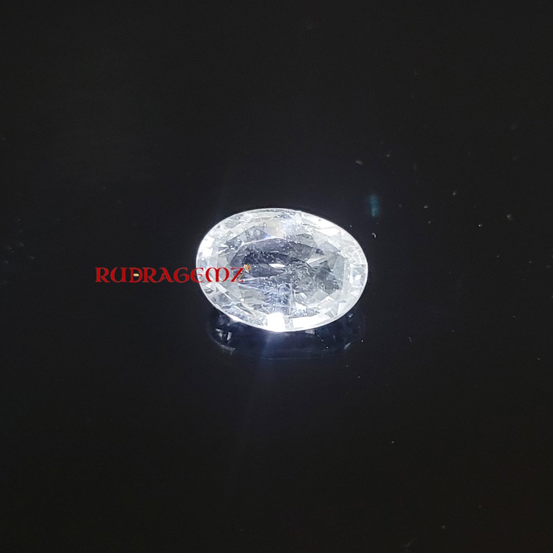 A polished White Topaz stone, known for its purity, positive energy, and astrological significance.