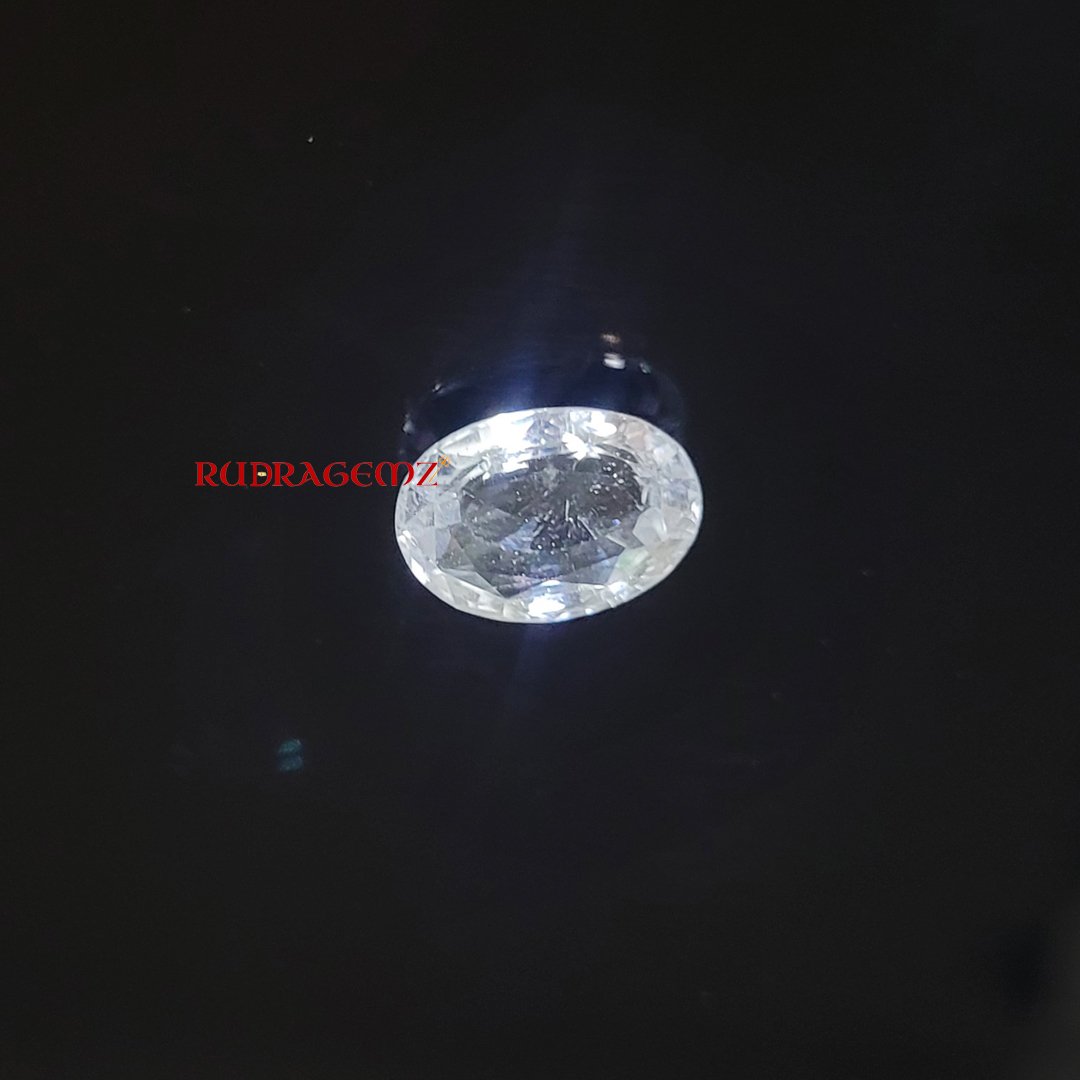 A polished White Topaz stone, known for its purity, positive energy, and astrological significance.