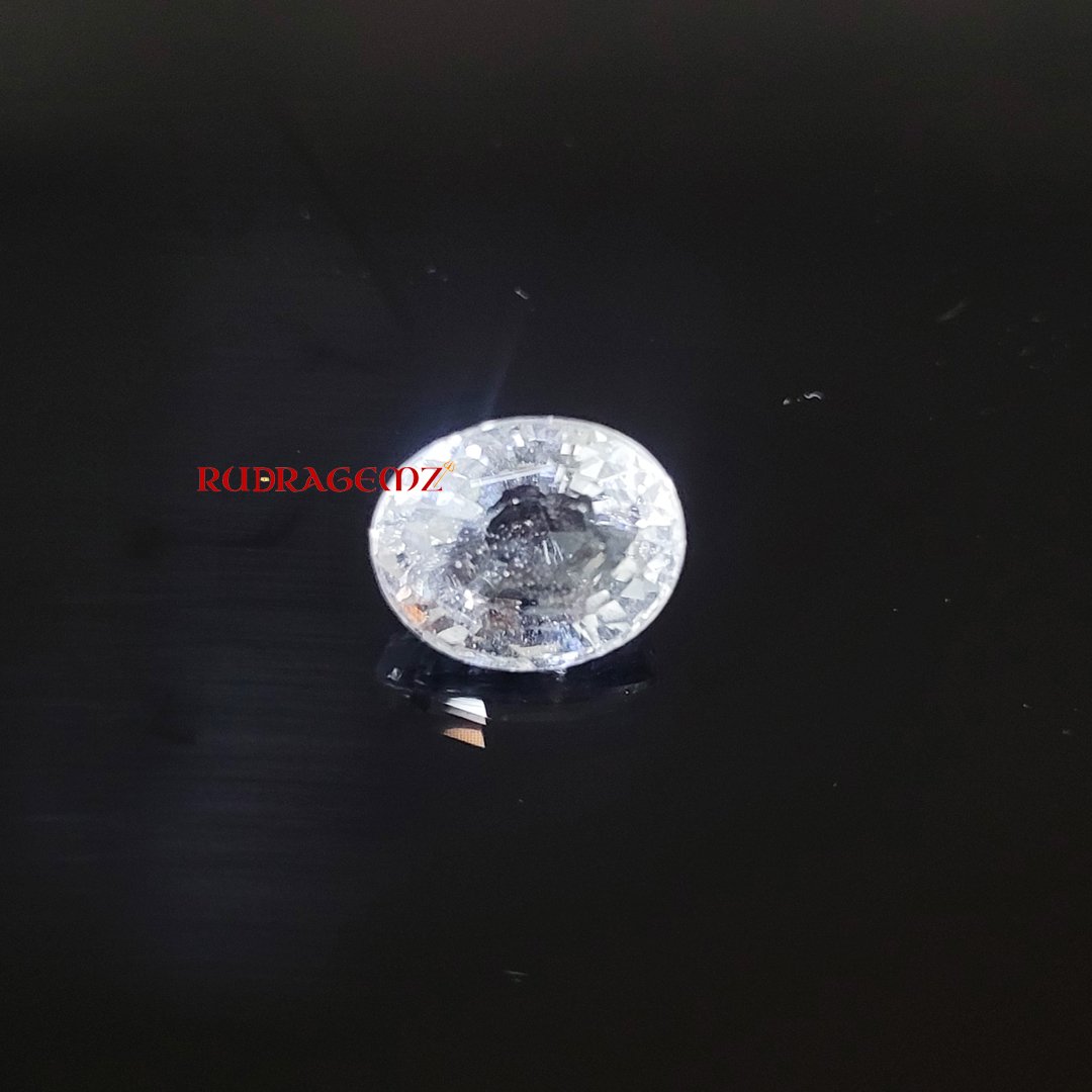 A polished White Topaz stone, known for its purity, positive energy, and astrological significance.