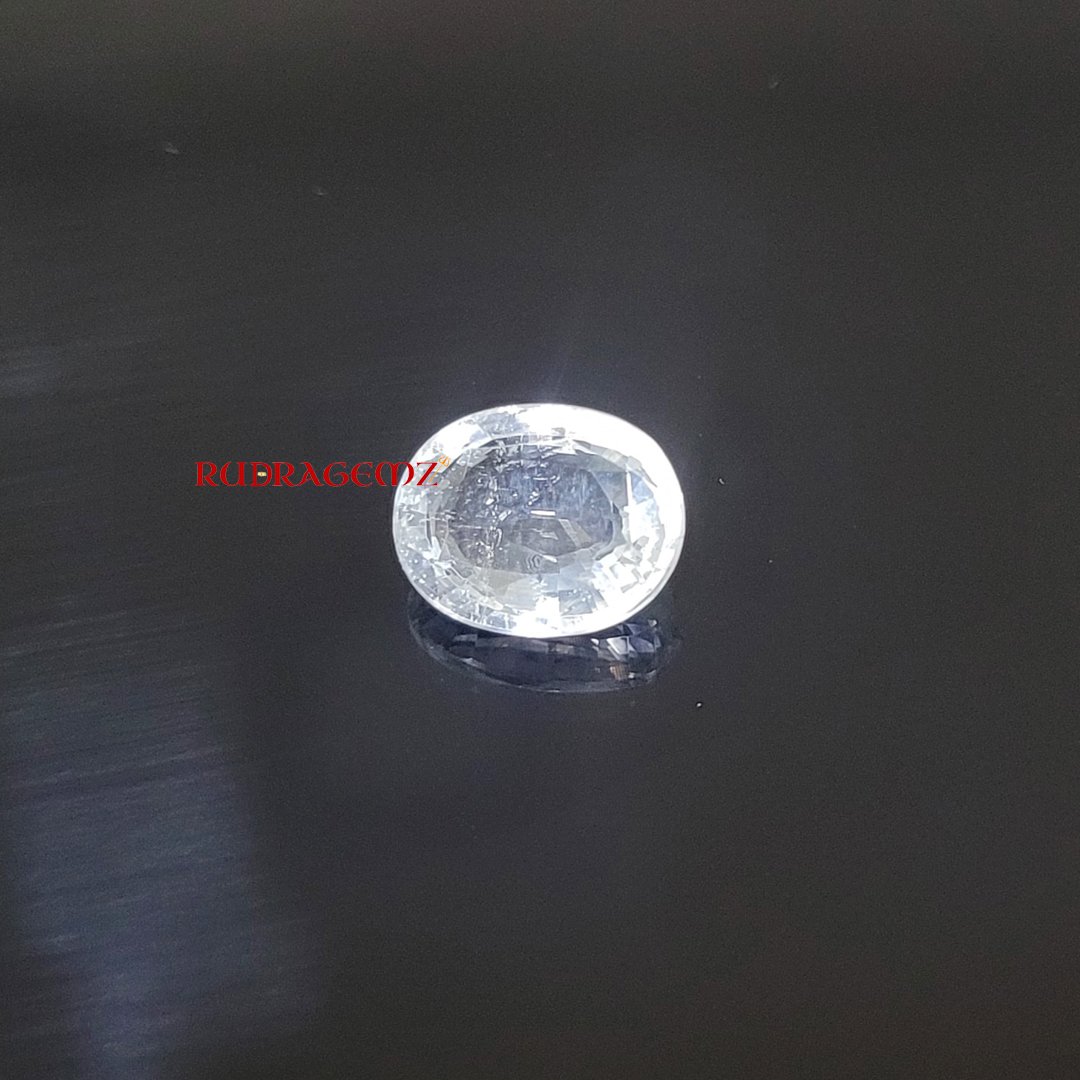 A polished White Topaz stone, known for its purity, positive energy, and astrological significance.