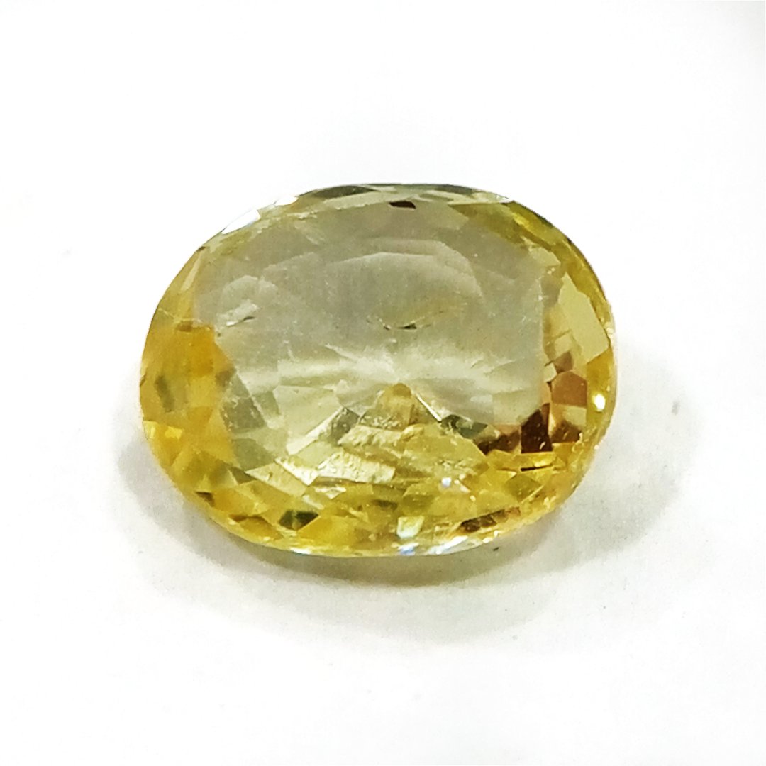 A high-quality Yellow Sapphire stone, known for its astrological benefits and association with Jupiter.