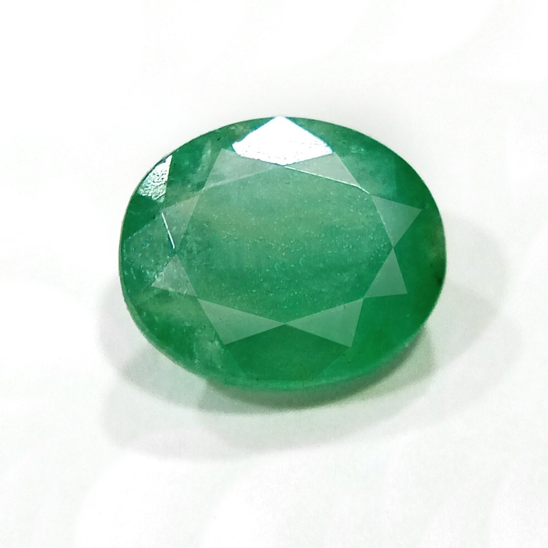 "Close-up of a radiant Zambian Emerald showcasing its vibrant green color and faceted cut."