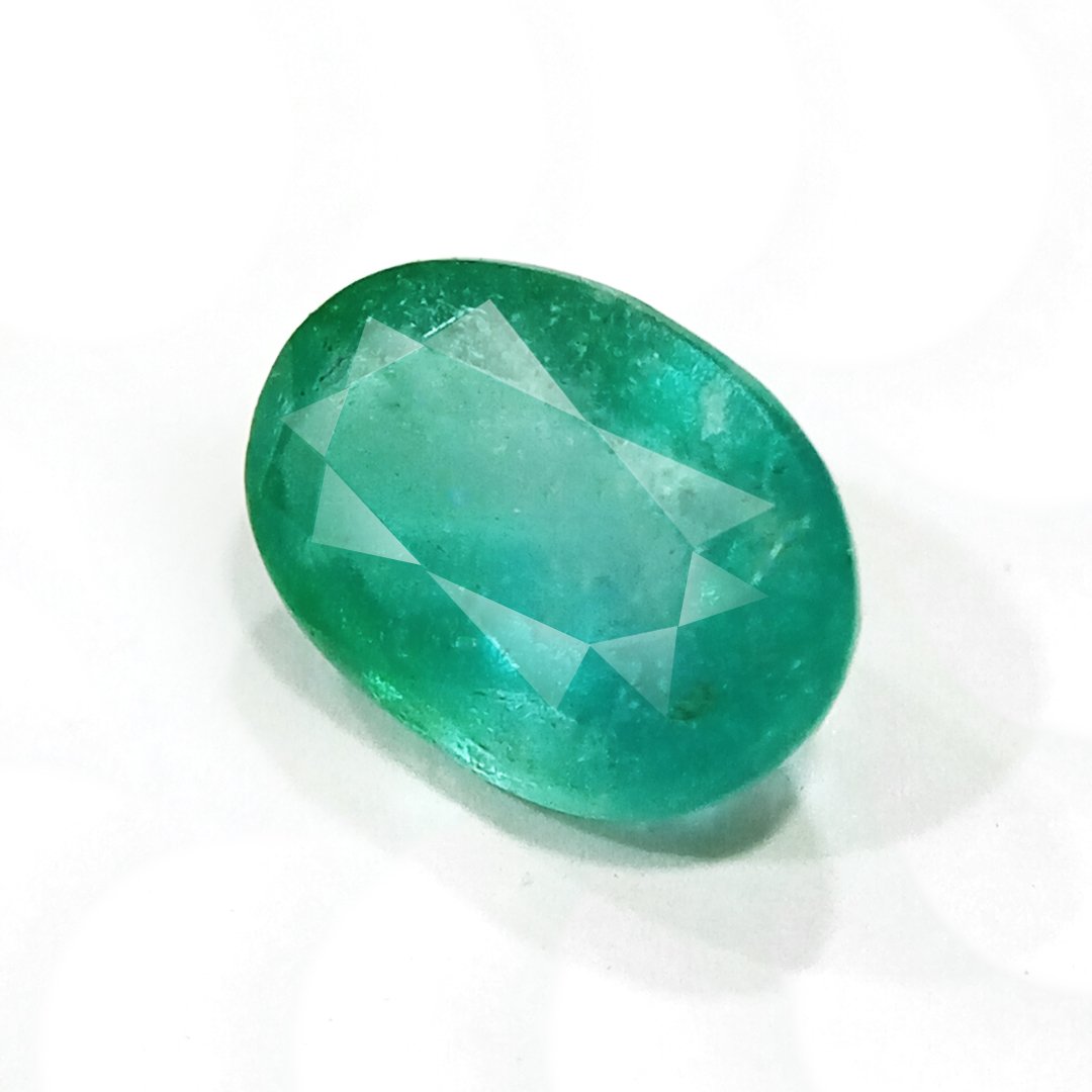 "Close-up of a radiant Zambian Emerald showcasing its vibrant green color and faceted cut."
