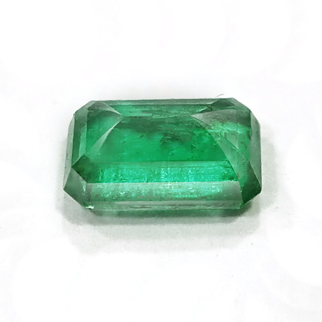 "Close-up of a radiant Zambian Emerald showcasing its vibrant green color and faceted cut."