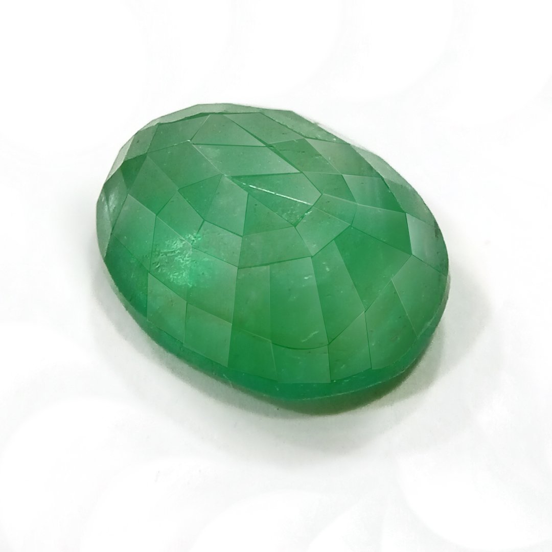 "Close-up of a radiant Zambian Emerald showcasing its vibrant green color and faceted cut."