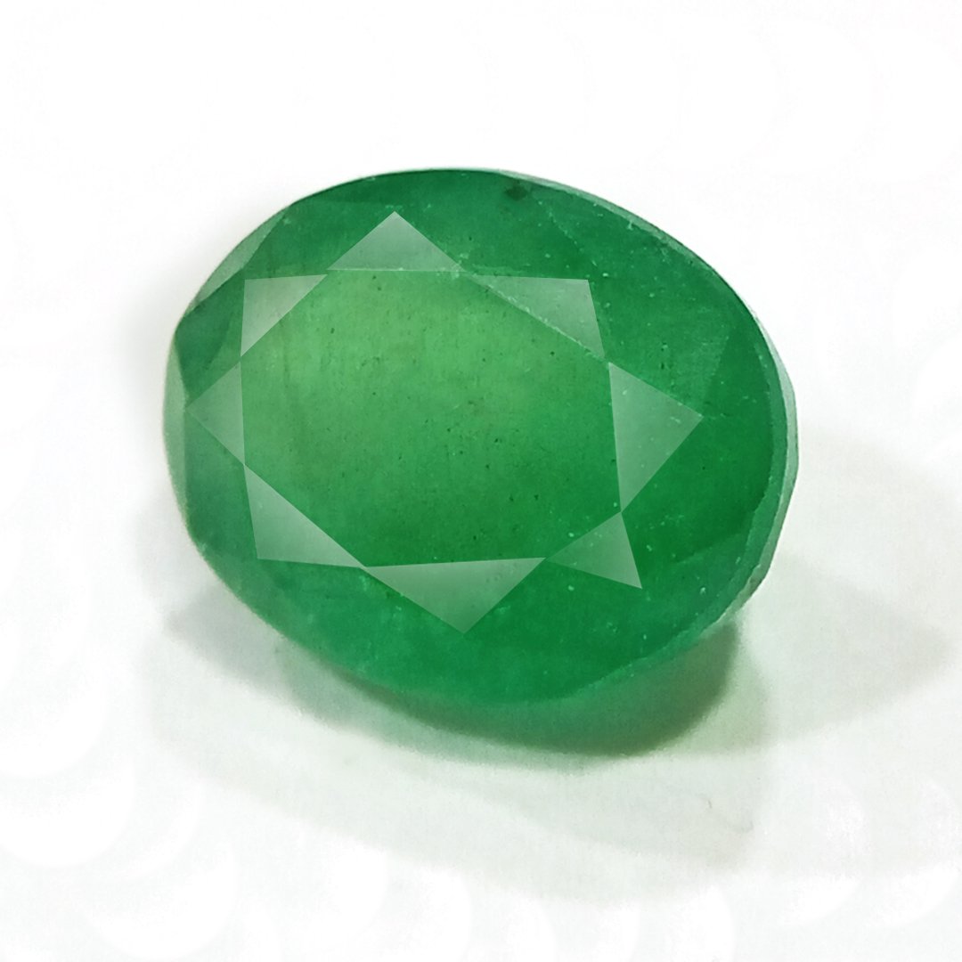 "Close-up of a radiant Zambian Emerald showcasing its vibrant green color and faceted cut."