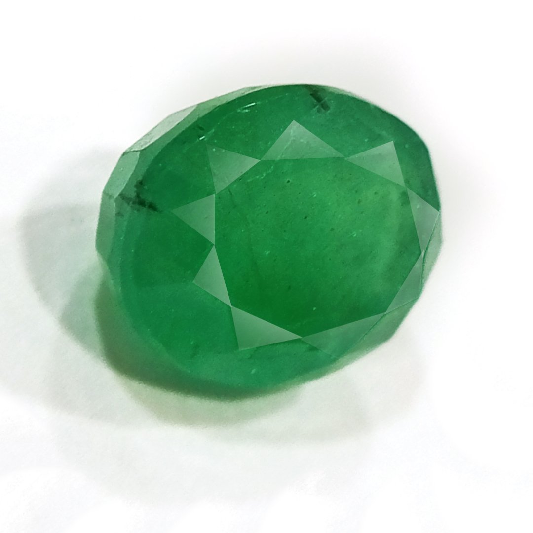 "Close-up of a radiant Zambian Emerald showcasing its vibrant green color and faceted cut."