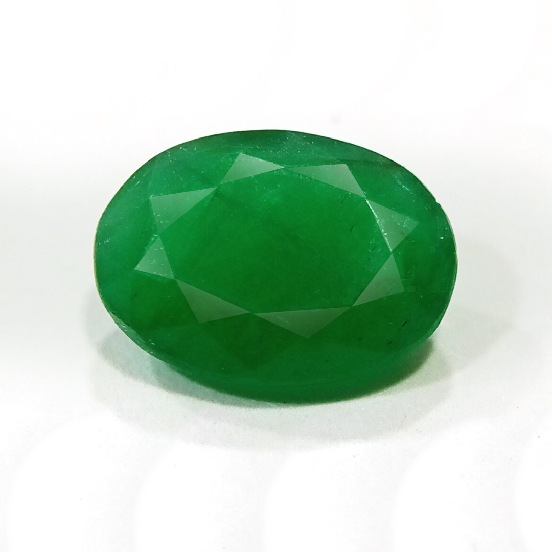 "Close-up of a radiant Zambian Emerald showcasing its vibrant green color and faceted cut."