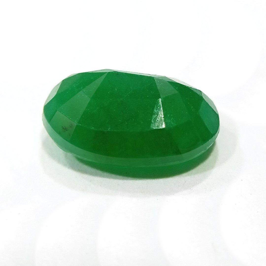 "Close-up of a radiant Zambian Emerald showcasing its vibrant green color and faceted cut."
