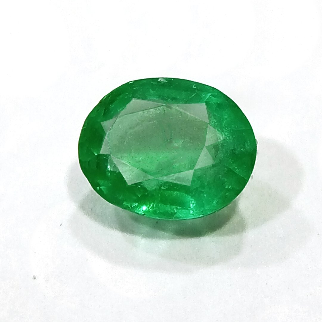 "Close-up of a radiant Zambian Emerald showcasing its vibrant green color and faceted cut."