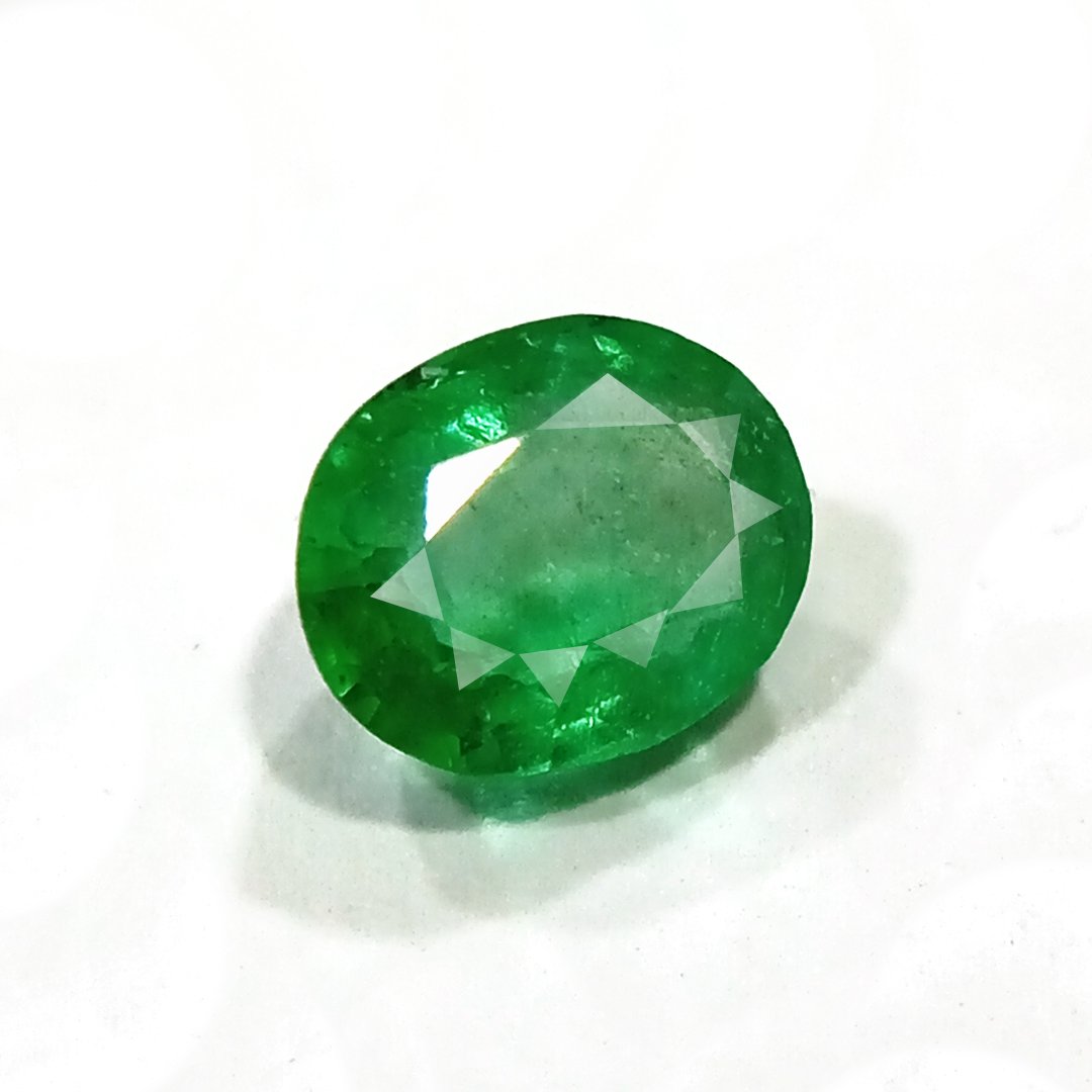 "Close-up of a radiant Zambian Emerald showcasing its vibrant green color and faceted cut."