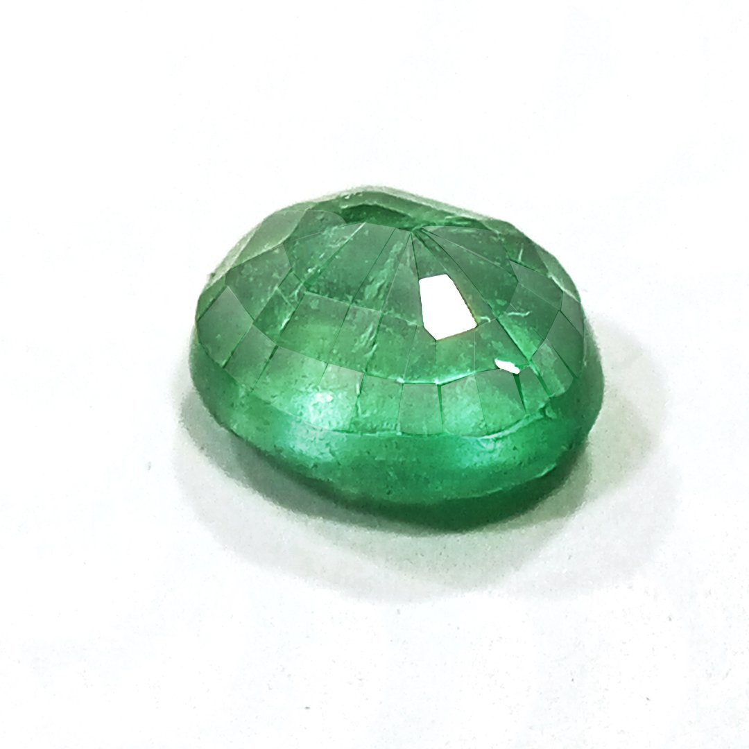 "Close-up of a radiant Zambian Emerald showcasing its vibrant green color and faceted cut."
