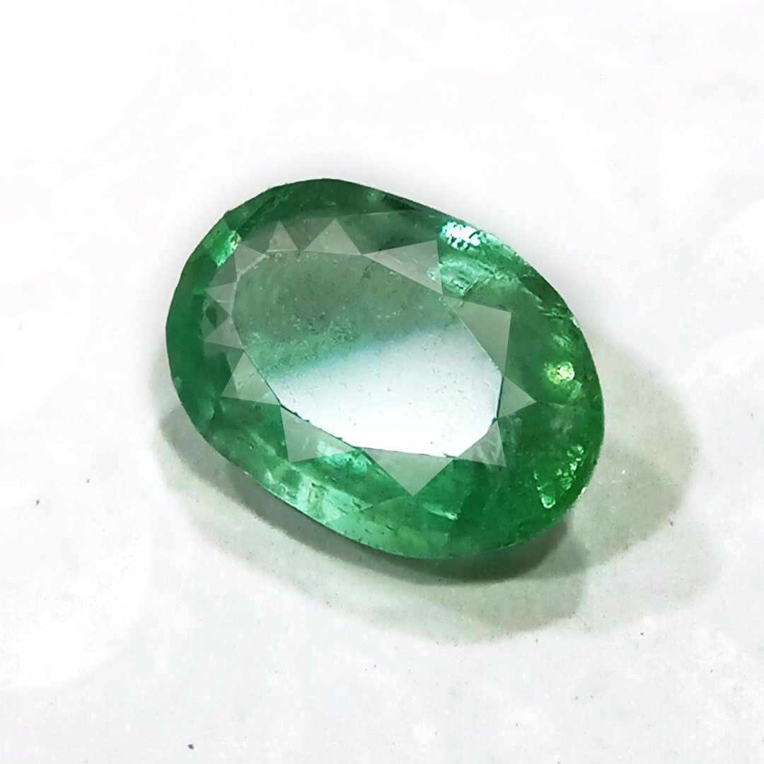 "Close-up of a radiant Zambian Emerald showcasing its vibrant green color and faceted cut."