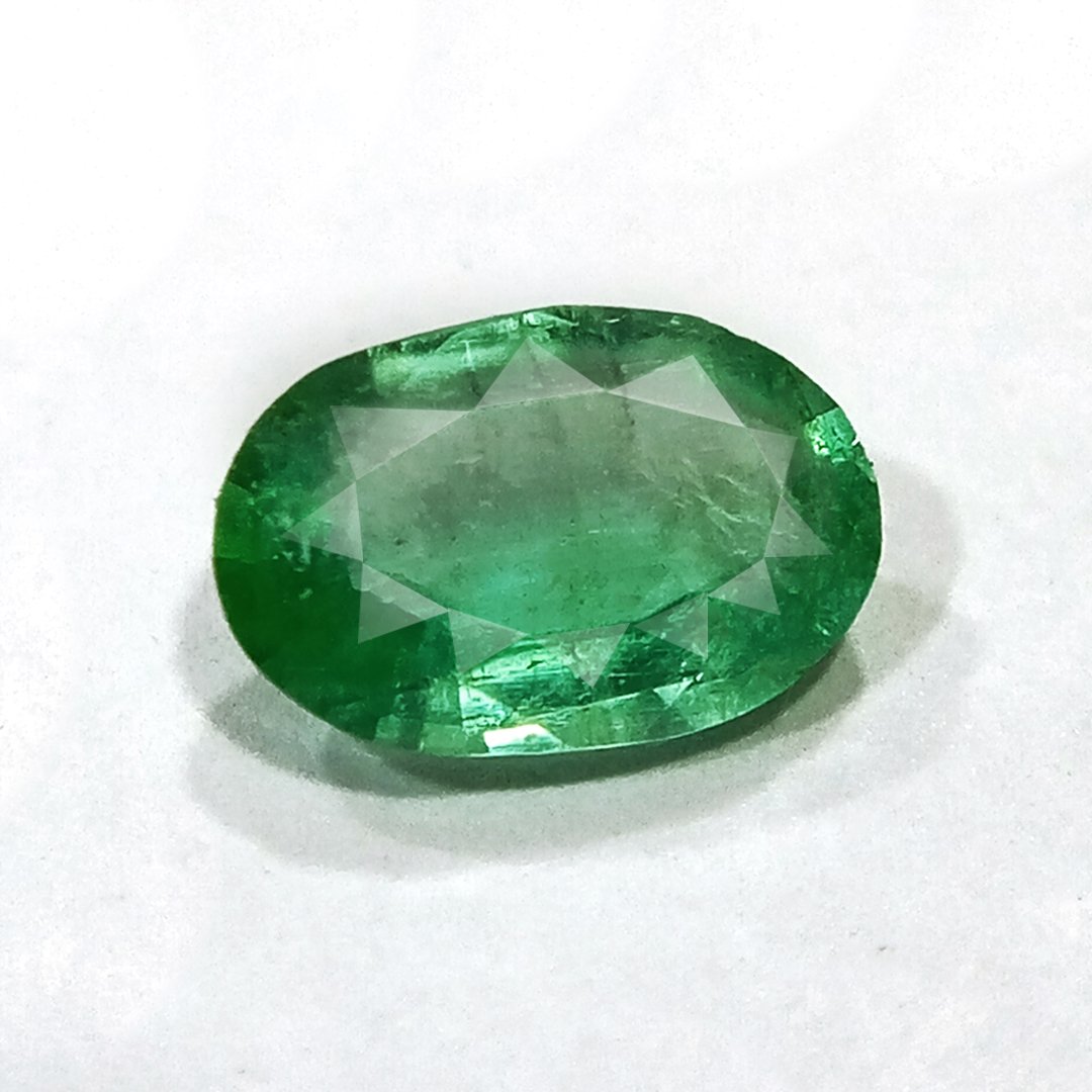 "Close-up of a radiant Zambian Emerald showcasing its vibrant green color and faceted cut."