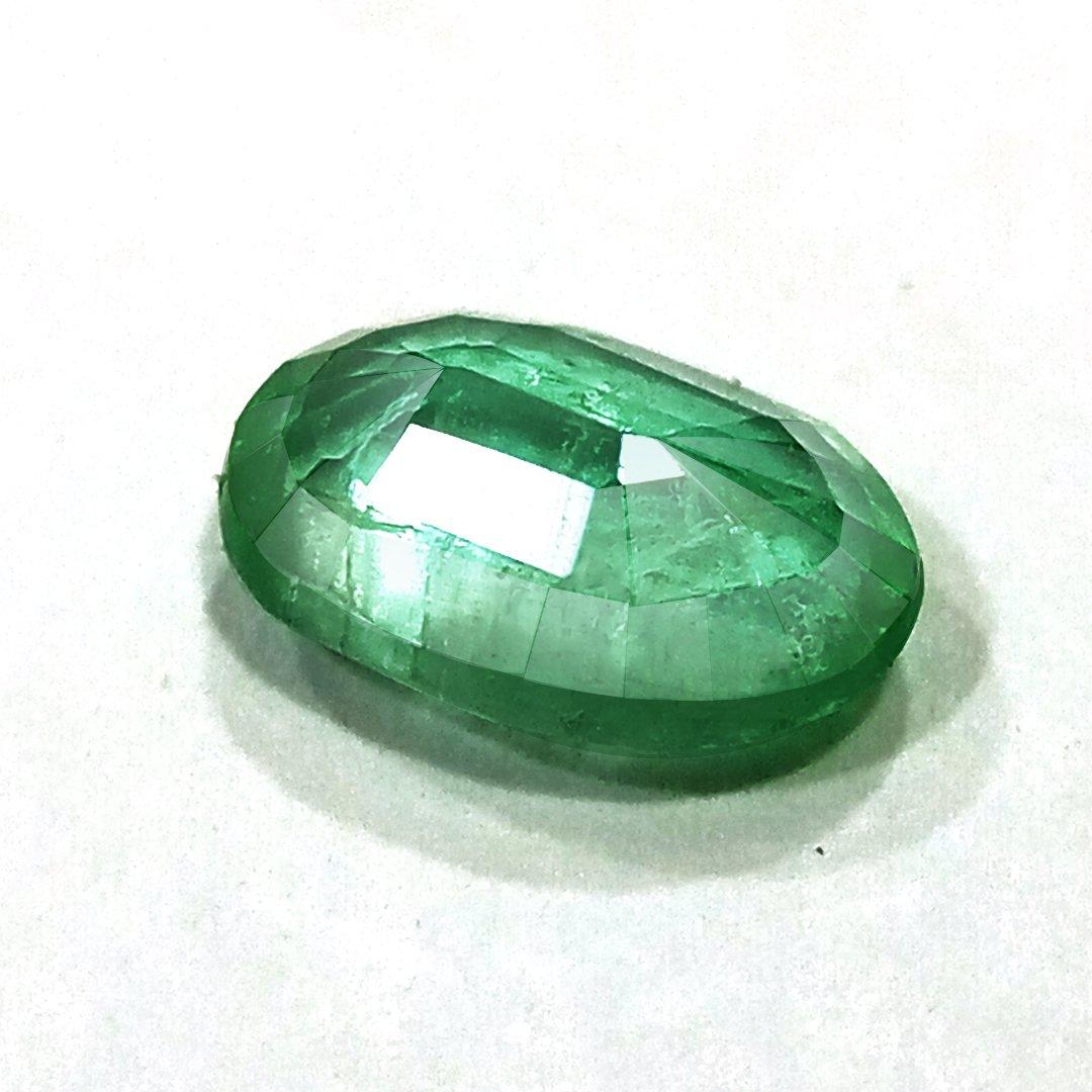 "Close-up of a radiant Zambian Emerald showcasing its vibrant green color and faceted cut."