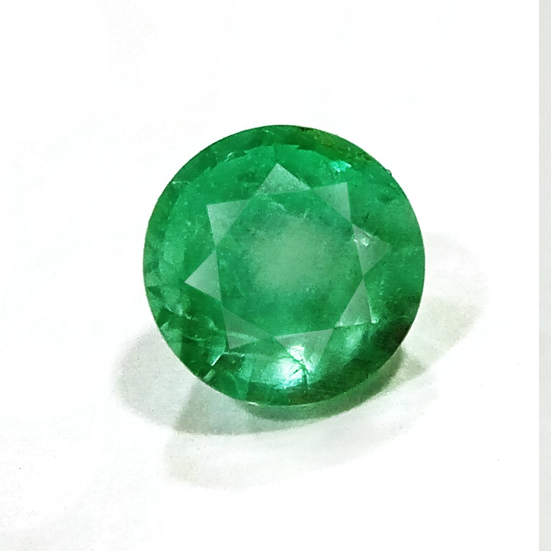 "Close-up of a radiant Zambian Emerald showcasing its vibrant green color and faceted cut."
