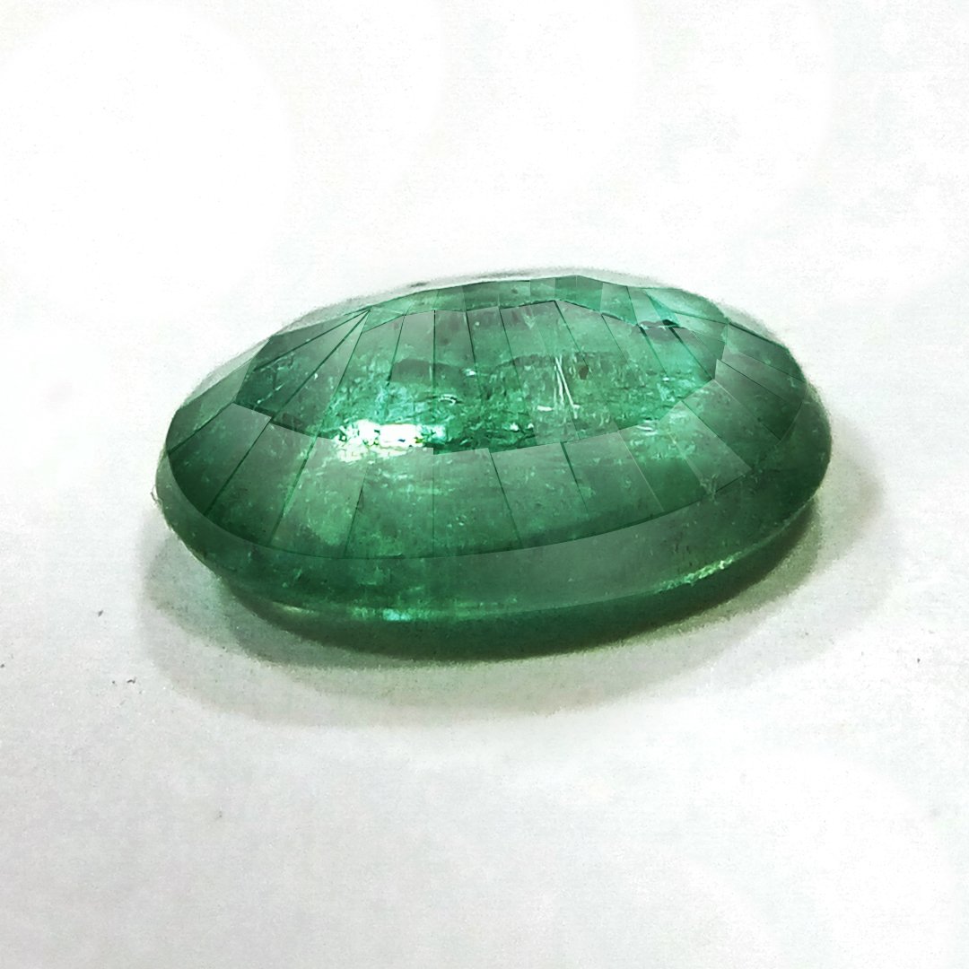 "Close-up of a radiant Zambian Emerald showcasing its vibrant green color and faceted cut."
