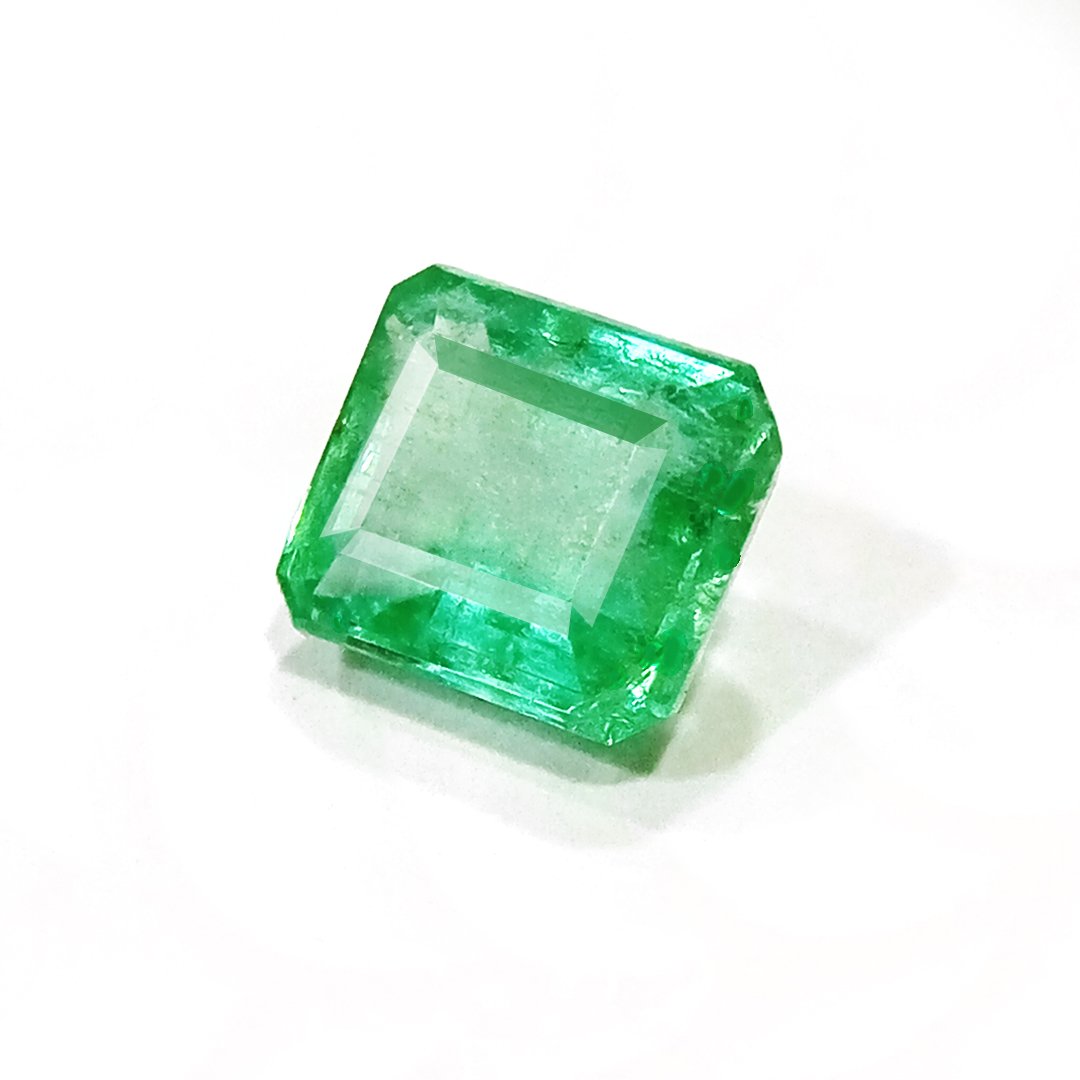 "Close-up of a radiant Zambian Emerald showcasing its vibrant green color and faceted cut."