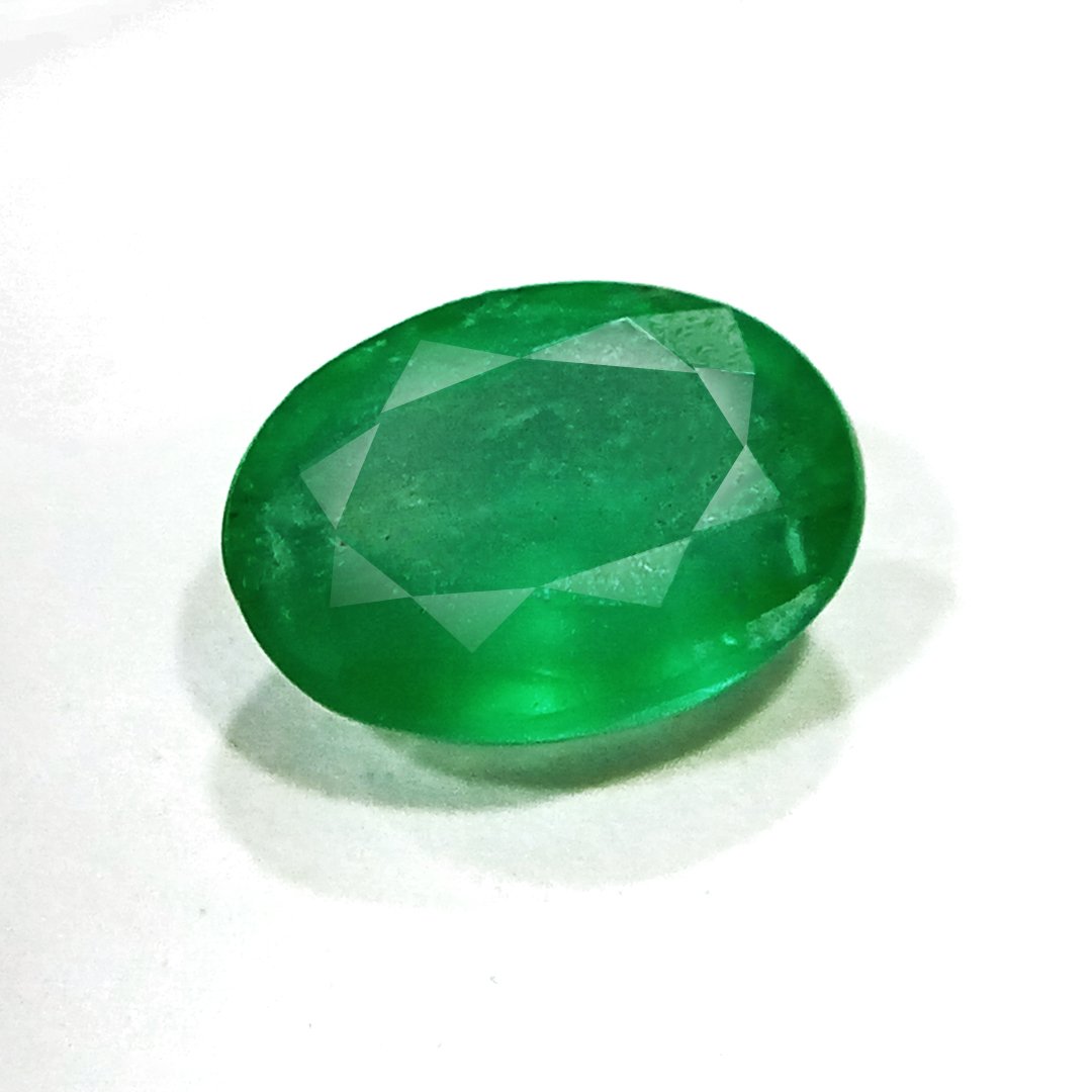 "Close-up of a radiant Zambian Emerald showcasing its vibrant green color and faceted cut."