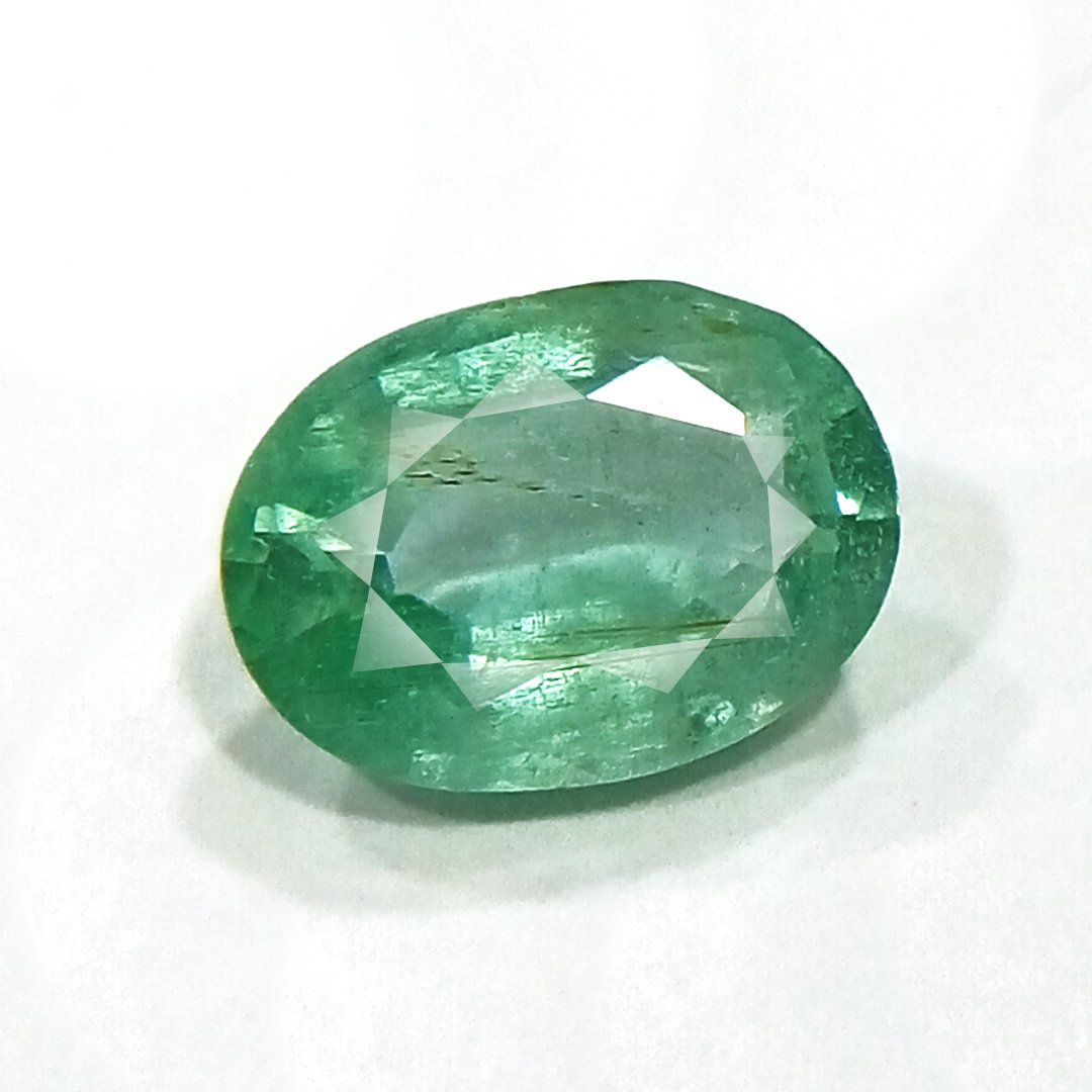 "Close-up of a radiant Zambian Emerald showcasing its vibrant green color and faceted cut."