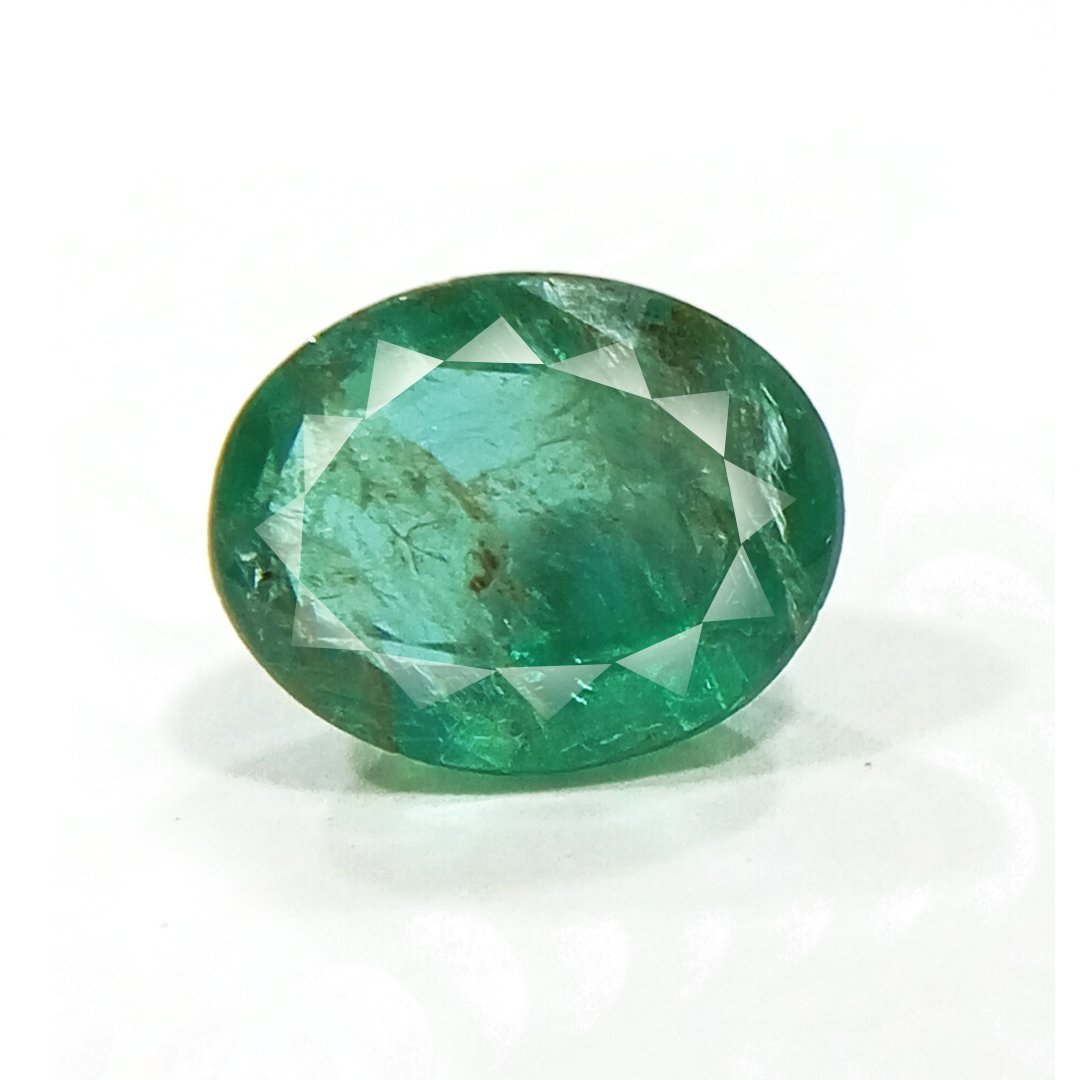 "Close-up of a radiant Zambian Emerald showcasing its vibrant green color and faceted cut."