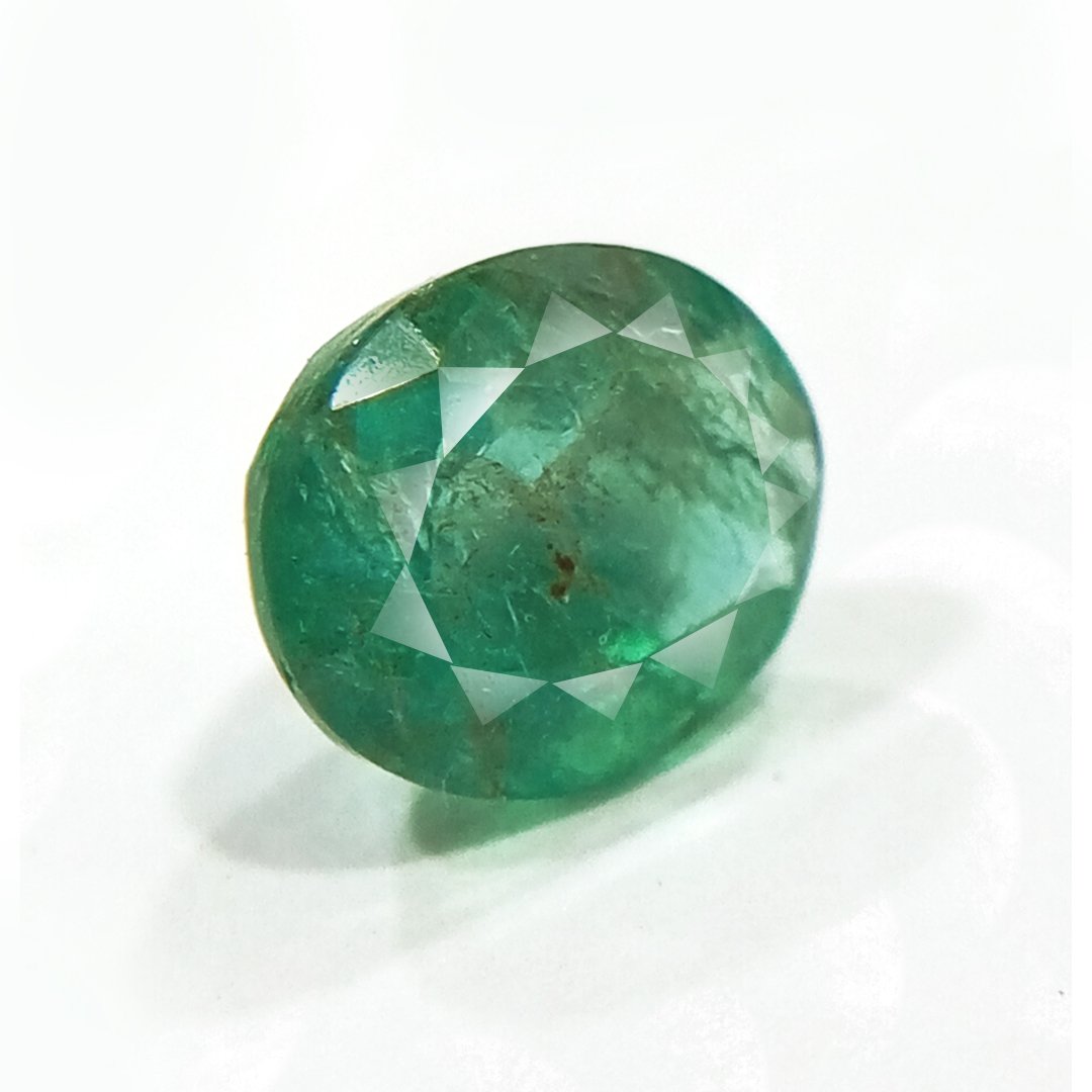"Close-up of a radiant Zambian Emerald showcasing its vibrant green color and faceted cut."
