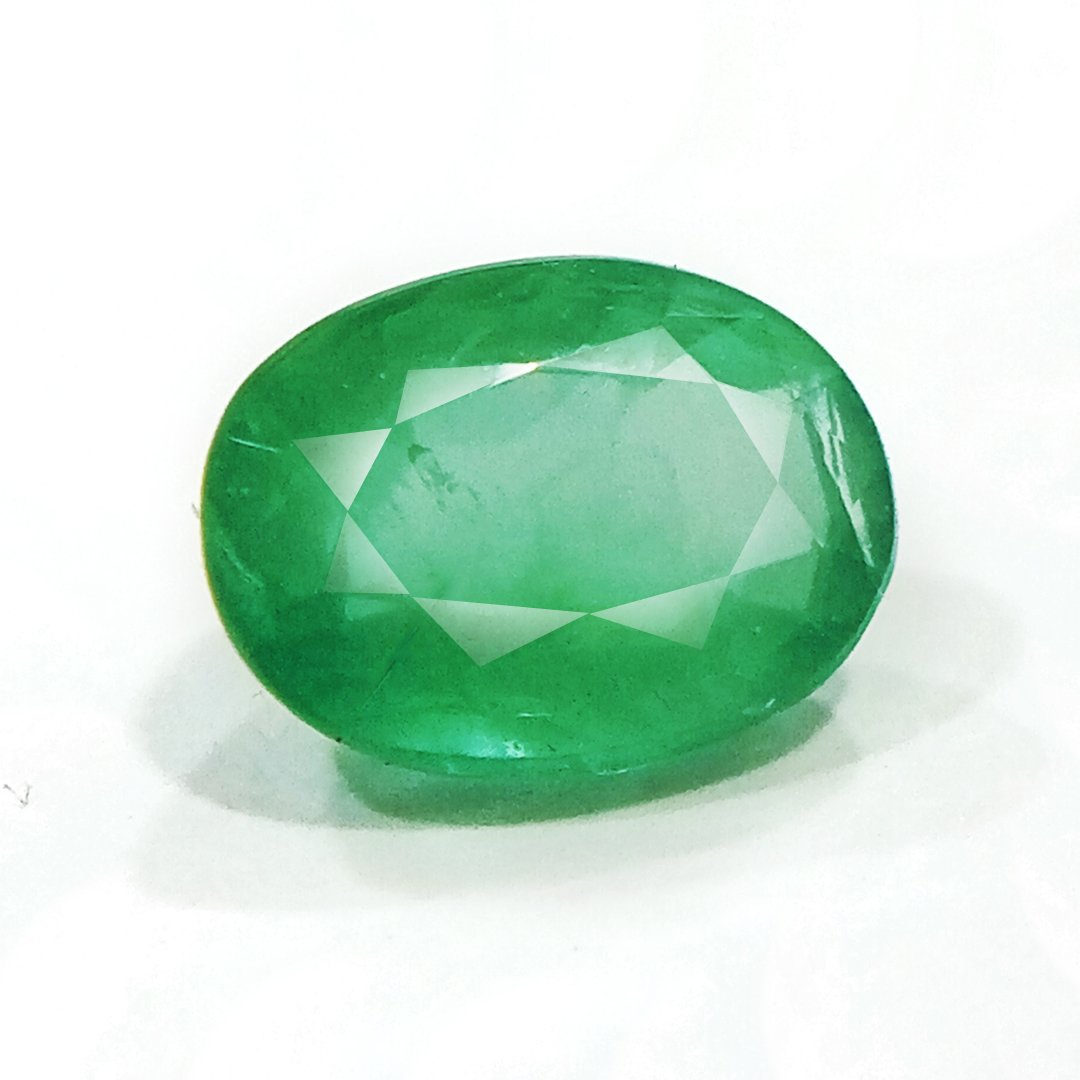 "Close-up of a radiant Zambian Emerald showcasing its vibrant green color and faceted cut."