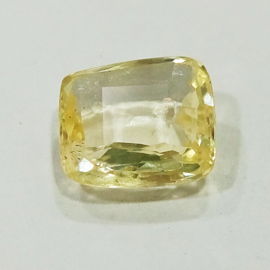 A high-quality Yellow Sapphire stone, known for its astrological benefits and association with Jupiter.