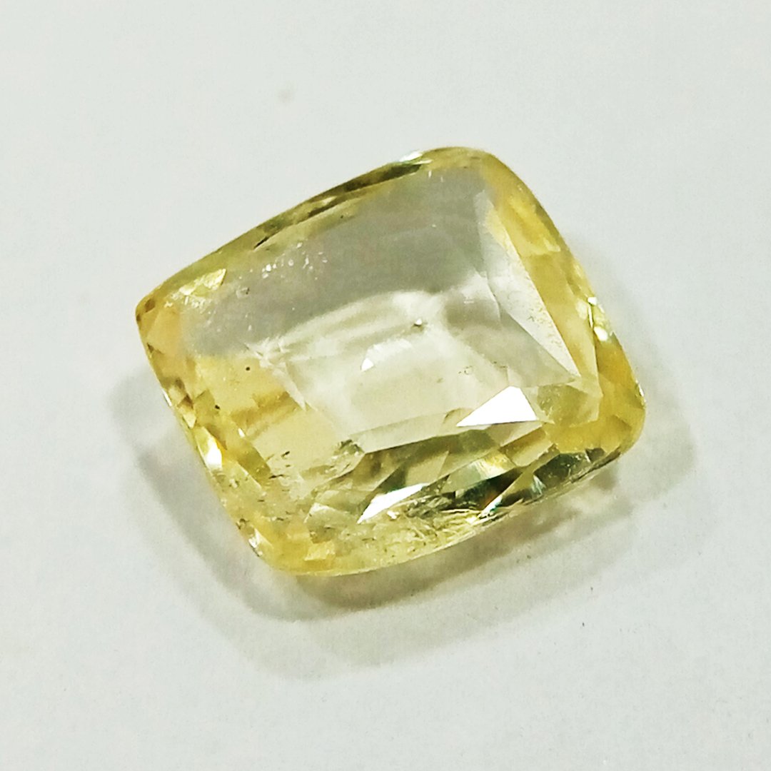 A high-quality Yellow Sapphire stone, known for its astrological benefits and association with Jupiter.