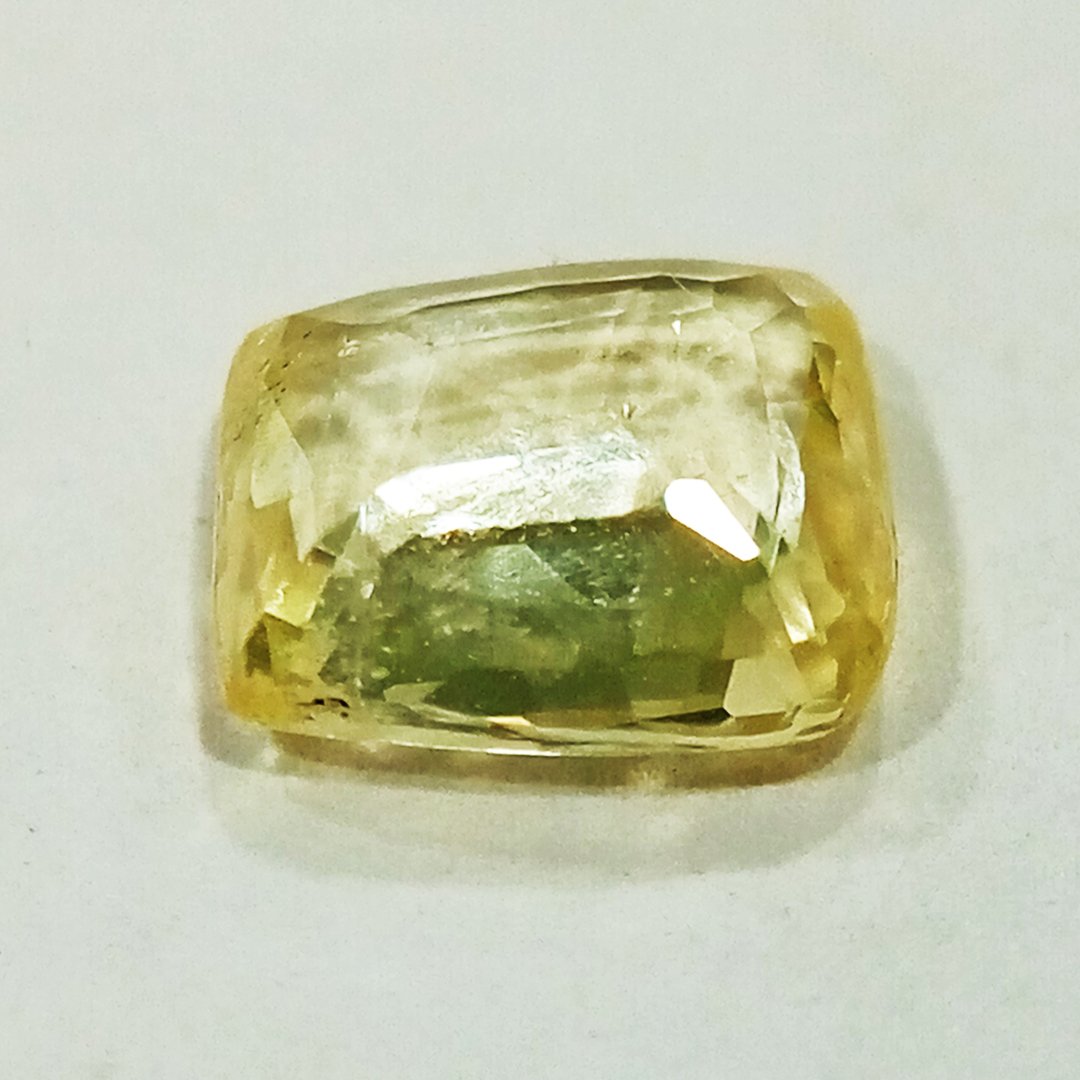 A high-quality Yellow Sapphire stone, known for its astrological benefits and association with Jupiter.