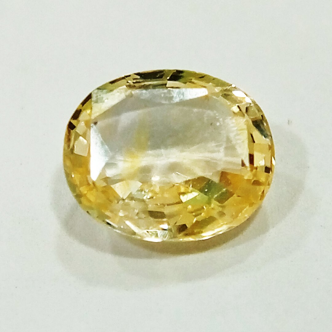 A high-quality Yellow Sapphire stone, known for its astrological benefits and association with Jupiter.