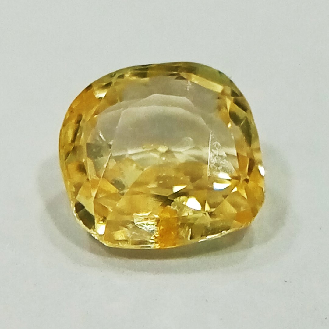 A high-quality Yellow Sapphire stone, known for its astrological benefits and association with Jupiter.
