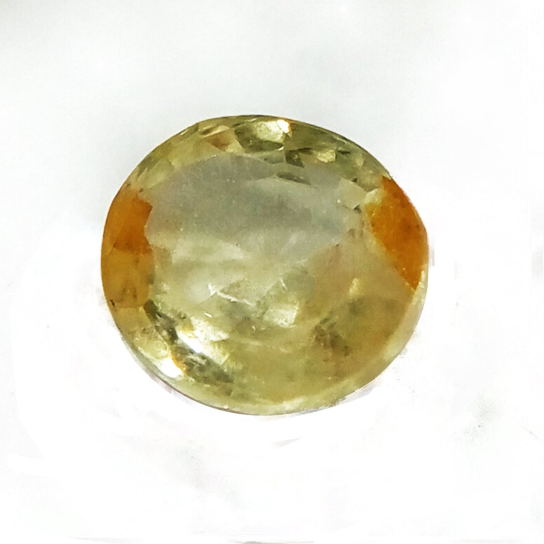 A high-quality Yellow Sapphire stone, known for its astrological benefits and association with Jupiter.