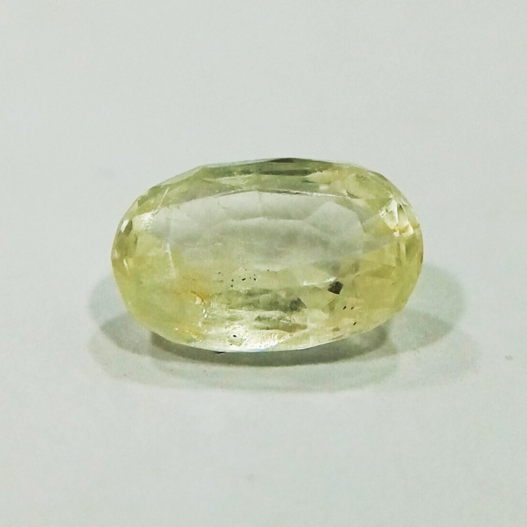 A high-quality Yellow Sapphire stone, known for its astrological benefits and association with Jupiter.