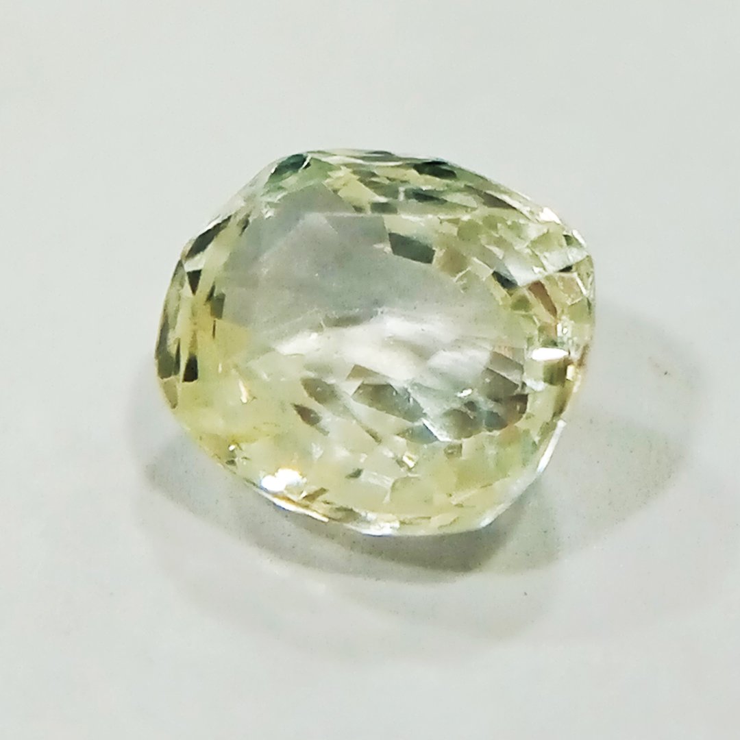 A high-quality Yellow Sapphire stone, known for its astrological benefits and association with Jupiter.