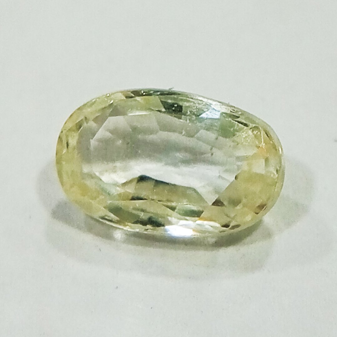 A high-quality Yellow Sapphire stone, known for its astrological benefits and association with Jupiter.